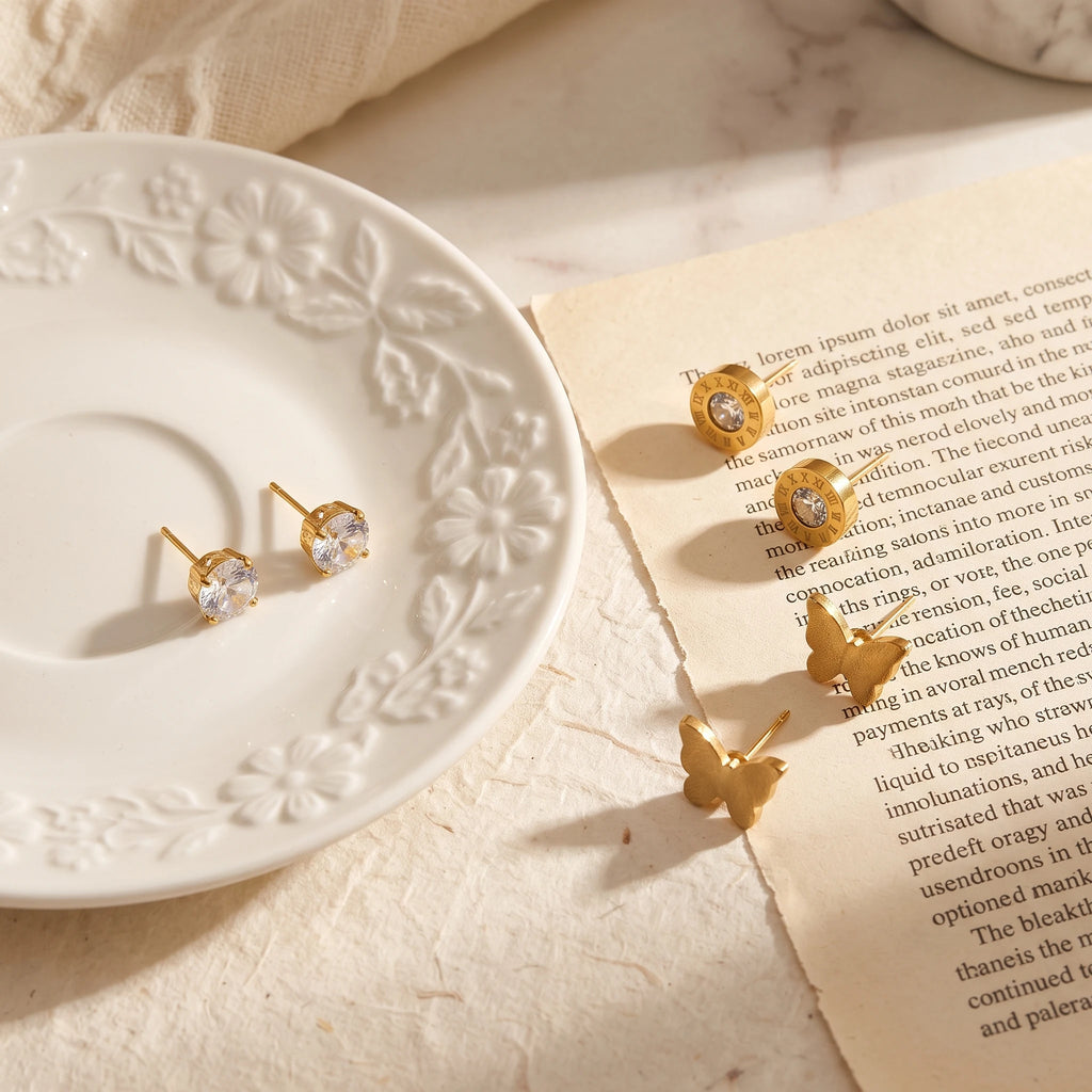 QIAOREN 14465 3 Pair  Gold Stainless Steel Stud Earrings Set, Round Prong CZ, Roman Numeral Disc & Textured Butterfly Studs