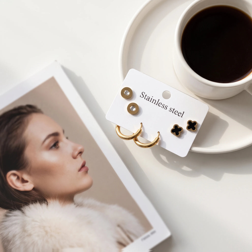 QIAOREN 14472 3 Pair Gold Stainless Steel Earrings Set, Round Disc CZ Studs, Black Enamel Clover Studs & Smooth Huggie Hoops