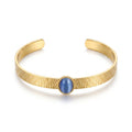 QIAOREN 13665 Textured Wave Open Cuff Bracelet with Oval Blue Cat Eye Stone Bezel Setting, Matte Brush Gold Adjustable Wrist