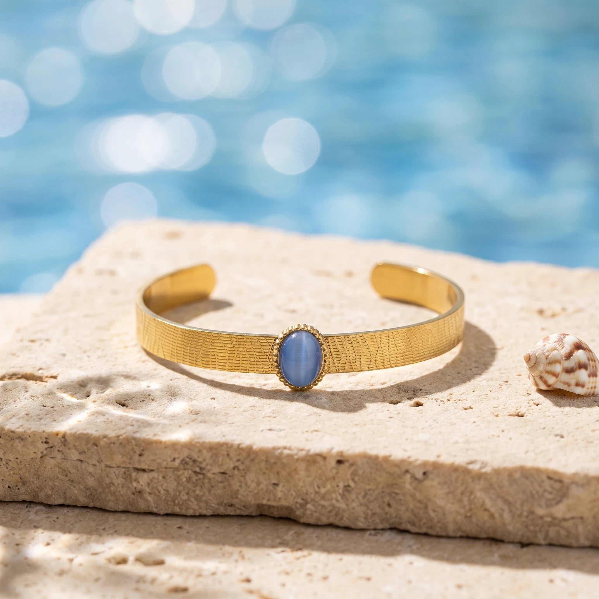 QIAOREN 13665 Textured Wave Open Cuff Bracelet with Oval Blue Cat Eye Stone Bezel Setting, Matte Brush Gold Adjustable Wrist