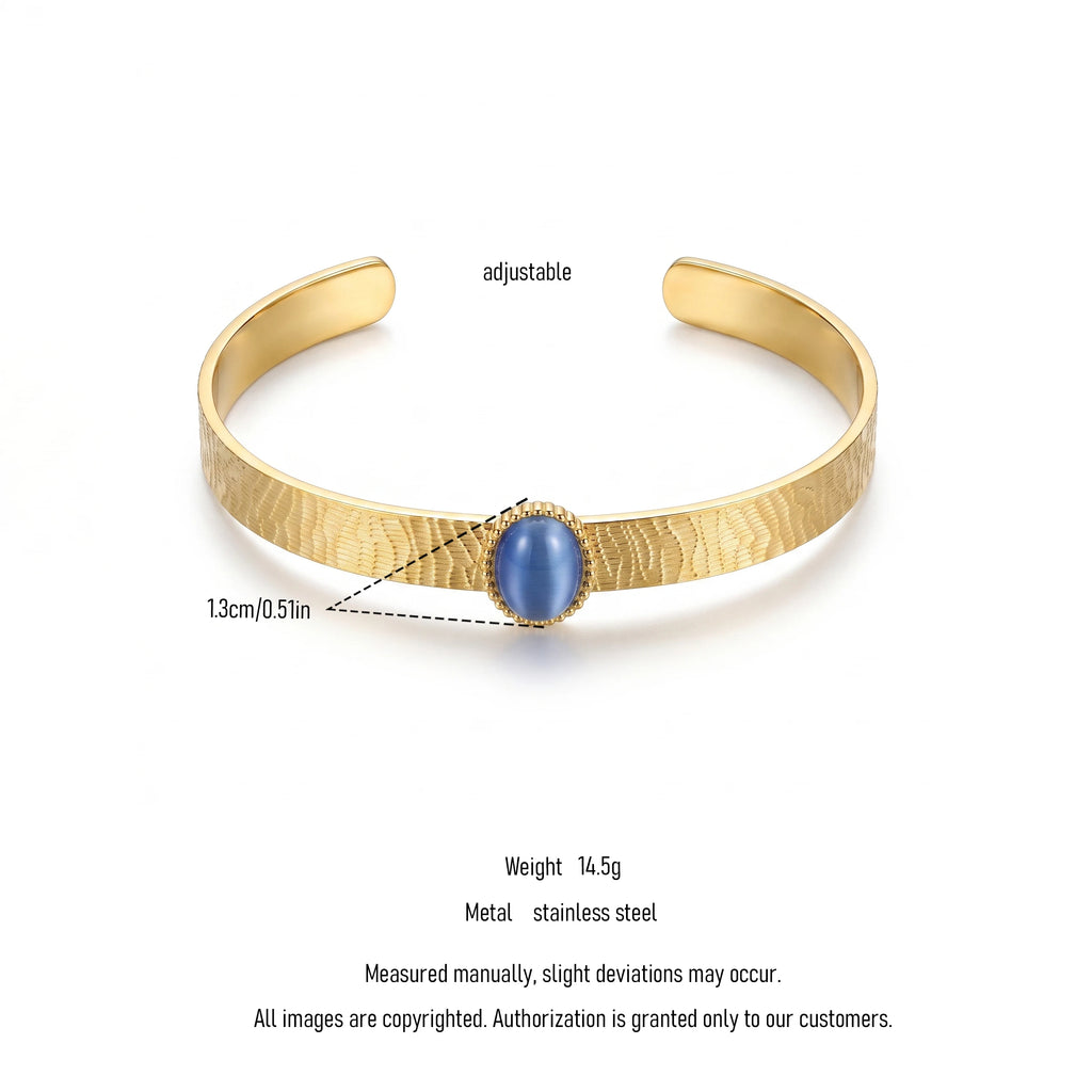 QIAOREN 13665 Textured Wave Open Cuff Bracelet with Oval Blue Cat Eye Stone Bezel Setting, Matte Brush Gold Adjustable Wrist