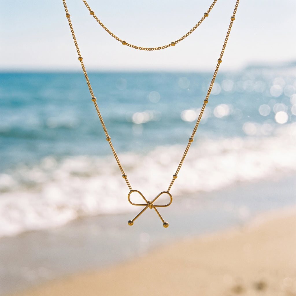 QIAOREN 13985 Beaded Oval Link Chain Pendant Necklace with Hollow Line Bow Charm, Polished Gold Minimalist Bow Collar