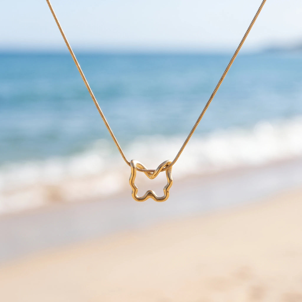 QIAOREN 13802 Thin Snake Chain Hollow Outline Butterfly Pendant Necklace with Beaded Border Texture Frame, Polished Matte Gold